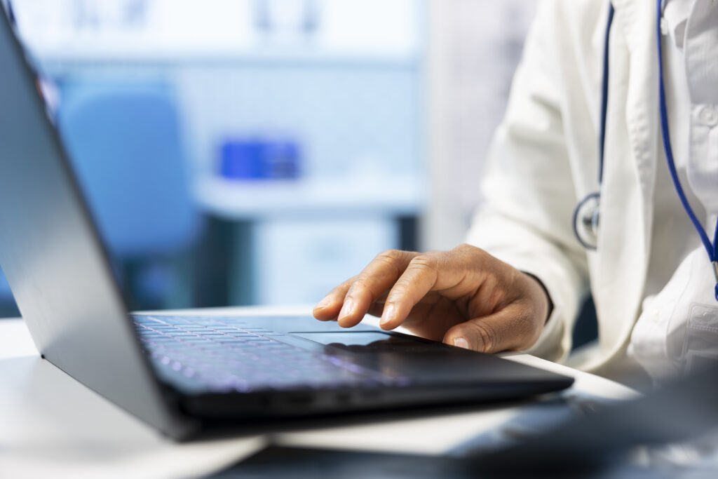 Licensed specialist examine healthcare records on laptop and x ray scan results